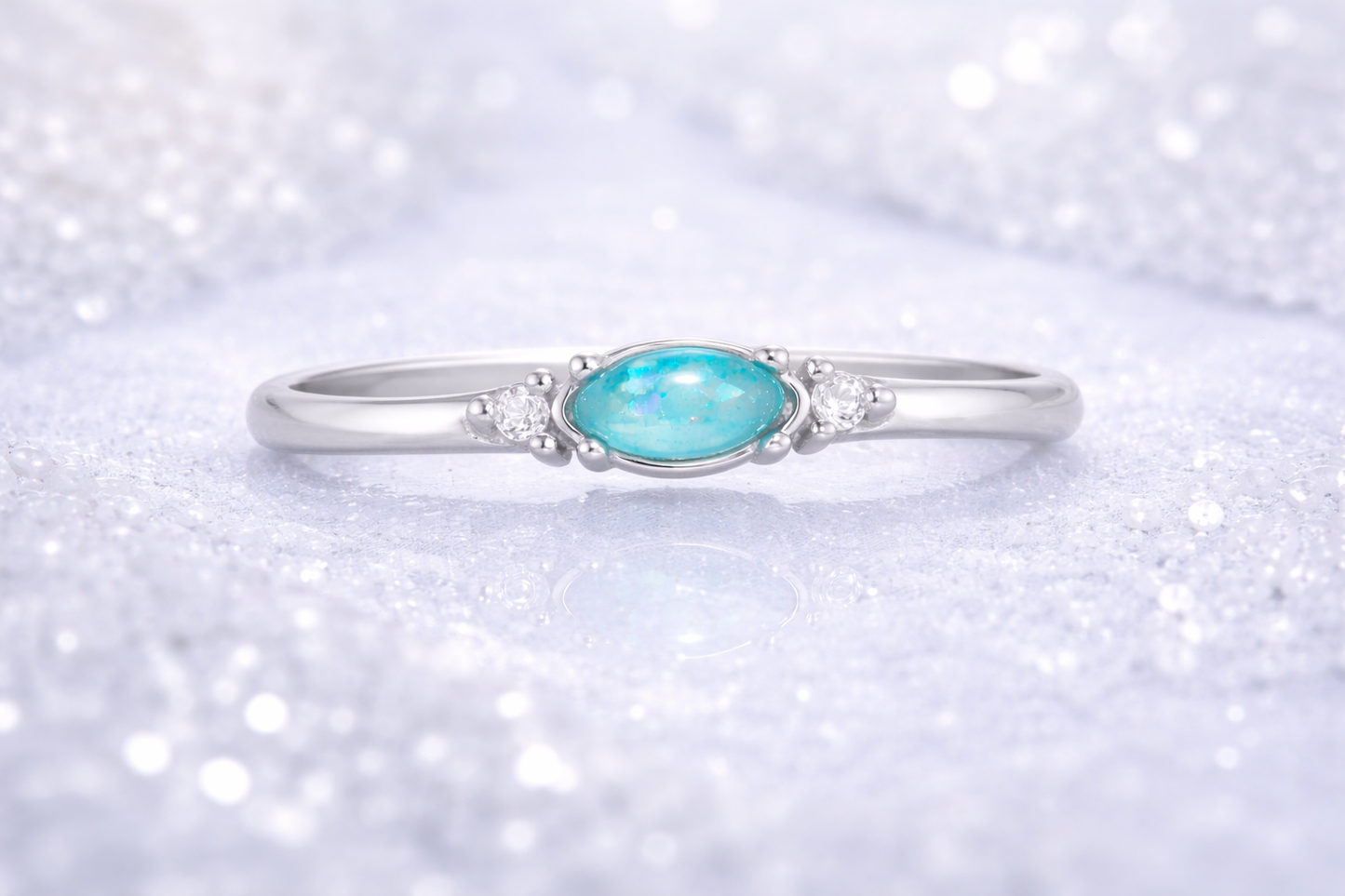 Ring Aqua mit blauem Zierstein auf gefrorenem Wasser